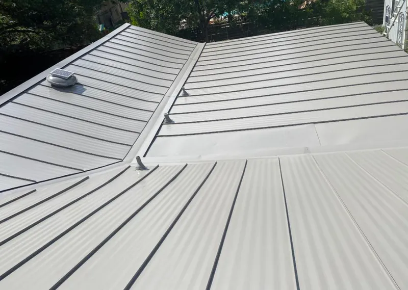 Solar attic fan installed on a metal roof for Roof Ventilation in Rainbow City